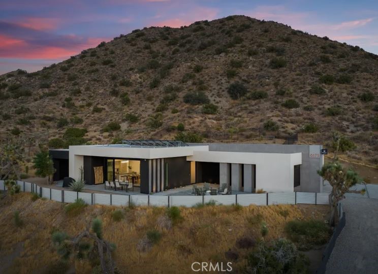 KING OF THE MOUNTAIN! Come and see this stunning modern retreat in Yucca Valley.
Discover this exceptional 21-acre property, a true oasis that combines luxury and comfort in the heart of the desert. Spanning an impressive 2,089 square feet, this modern build boasts three spacious bedrooms and three beautifully appointed baths, making it ideal for families or anyone seeking a serene getaway.
Step inside to find high ceilings that create an airy ambiance throughout the open kitchen and living areas. The kitchen is designed for both functionality and style, perfect for entertaining or enjoying quiet evenings at home. Cozy up by the fireplace in the living room, providing warmth and a touch of elegance during cooler desert nights.
For fitness enthusiasts, the expansive garage includes a dedicated gym space, allowing you to maintain your workout routine without ever leaving the property. The three-car garage offers ample storage and convenience.
Outside, indulge in your private in-ground pool and spa, perfect for cooling off during hot summer days or unwinding under the stars; surrounded by privacy fencing perched on top of a mountain. The stunning mountain views and unique desert landscape enhance the already picturesque setting, providing a truly tranquil experience.
This property is not just a home; it’s a very successful vacation rental, making it a fantastic investment opportunity. Whether you're looking to escape to the desert or seeking a profitable venture, this Yucca Valley gem has it all.