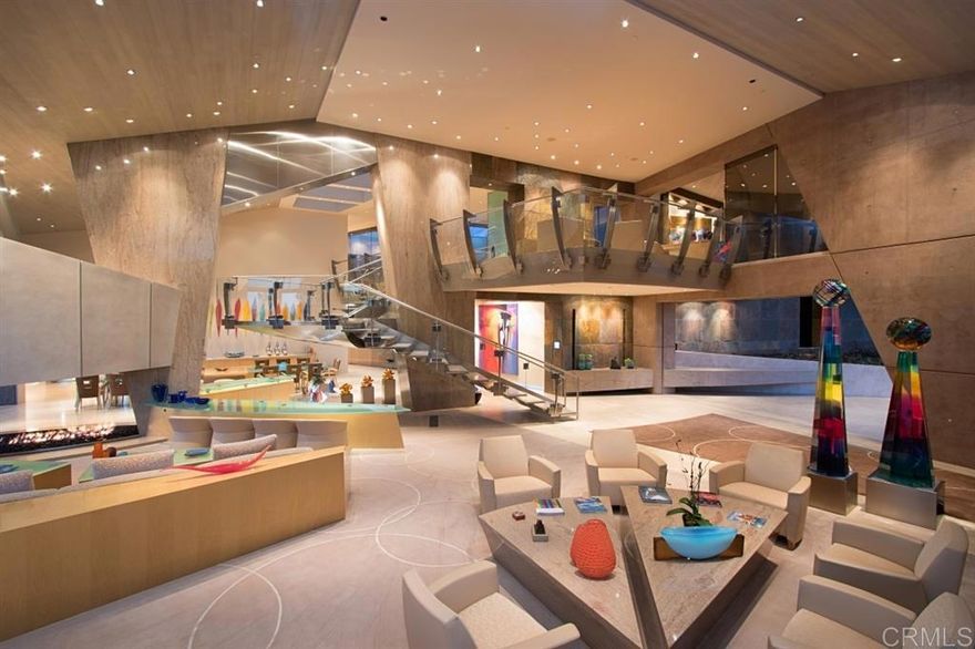 Ideally perched atop 33 acres, the most spectacular contemporary house ever constructed in the prestigious Rancho Santa Fe Covenant is introduced to the market. 7 years in the making this organic modern masterpiece delights the senses with all rooms open to walls of glass framing the stunning mountain and valley vista views. At 22,500 sq ft the estate offers ample space including 6+ over-sized bedrooms containing a dedicated master wing with panoramic views and his and hers everything. (see supplement) [Supplement]: The gourmet kitchen is ideal for any entertaining situation yet maintains a warmth and good feel for such a large room. Not surprising, the house is completely self-sufficient with solar panels fully powering the home and amenities, resulting in little to zero cost on the electricity bill. State of the art smart home features simplify life and allow instantaneous remote access. Gallery gardens with exotic plants and flowers imported from the regions of South America, South Africa and Australia surround pool and water features designed with seamless integration between the home and landscape that creates tranquility and evoke moments of contemplation and happiness. Surrounding citrus orchards and flora communities have created a habitat for the indigenous butterflies, bees and humming birds. Healthy living and fun are anchored between a cricket lawn, putting green, professional grade sports court and private stadium style tennis court.