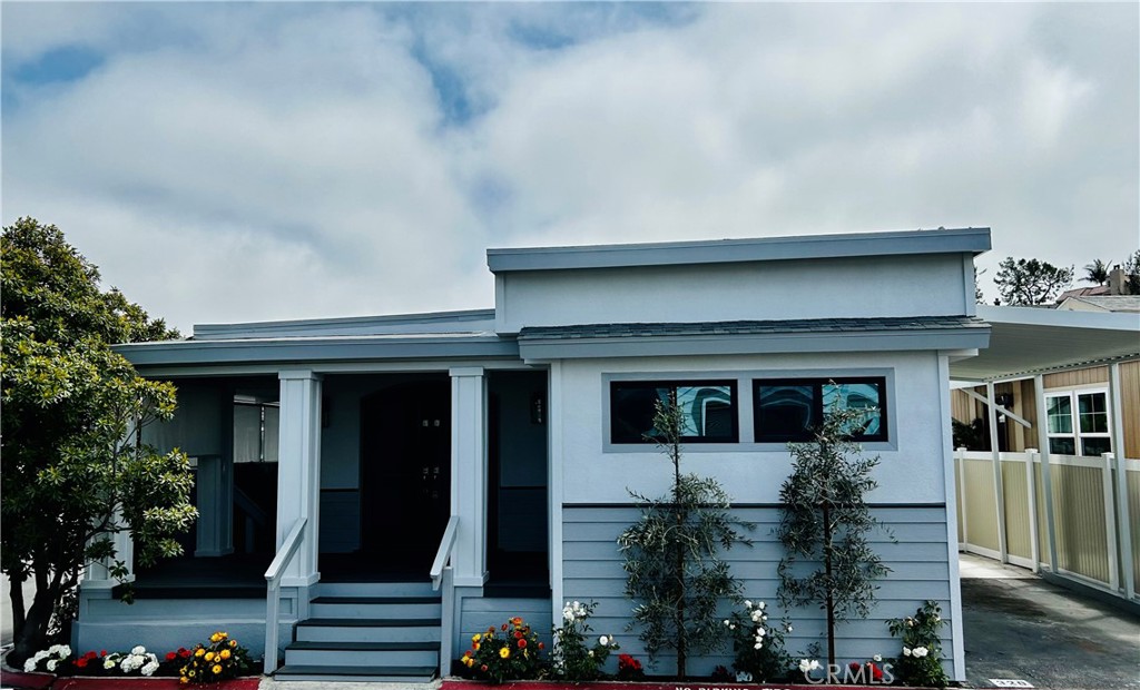 Nestled in the beautiful seaside community of Bayside Village Mobile Home Community sets this completely rebuilt and reimagined 3 bdrm, 2 bath manufactured home. Situated on a large corner lot with rare 2 car parking, this home truly does not disappoint as it is impeccably designed with fine finishes such as Quartz counter tops and custom porcelain tile, level 5 smooth coat walls, recessed lighting and beautiful laminate floors. As you enter the home through the double dutch doors, just past the sweeping front porch the living space awaits you featuring tongue and grove ceilings and walls and a gas fireplace. Adjacent is a large and functional kitchen offering a plethora of storage and top of the line stainless steel appliances and farm sink creating great prep space for cooking and entertaining. Both baths feature custom tile showers with quartz counters. Outside the large deck space is a great space to relax and enjoy the beach weather. This home also has air conditioning, a tankless water heater and an EV charger. Total sq ftg is 1404. There is an assumable land lease on this property of $2890 per month ($110 below the market lease) and includes water, sewer and trash with many fine amenities including 2 CLUBHOUSES, 2 STATE OF THE ART HEATED POOLS (one over looking the bay) 2 JACUZZIS, A PRIVATE BEACH WITH 2 GAS FIRE PITS, A GAME ROOM AND A FITNESS CENTER, WEEKLY STREET SWEEPING AND NIGHTLY SECURITY. BOAT SLIPS, GARAGES AVAILABLE FOR RENT. WITHIN WALKING DISTANCE TO SEVERAL BEACH ATTRACTIONS, WORLD CLASS RESTAURANTS, SHOPPING INCLUDING BALBOA ISLAND, FASHION ISLAND AND THE BACK BAY. ENJOY MANY FINE ACTIVITIES AT BAYSIDE VILLAGE SUCH AS KAYAKING, PADDLE BOARDING and BOATING. WALK THE LOCAL NATURE TRAILS, VISIT THE FRESH SEAFOOD MARKET AND SO MUCH MORE. Come live the Newport Beach lifestyle for less. No land taxes. New residents subject to park approval by Bayside Village Mngt. Land Leases subject to annual increases.