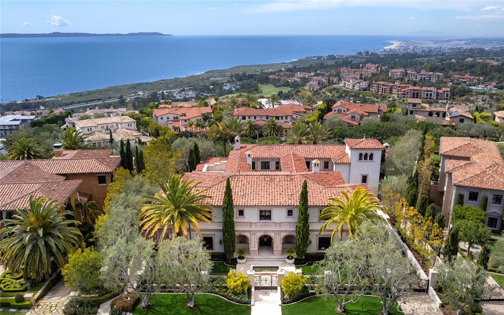 Welcome to this recently updated luxurious coastal retreat nestled within the prestigious confines of Crystal Cove, a haven of exclusivity and security. This palatial estate sits within the second set of gates reserved for custom homesites, ensuring privacy and tranquility for its residents. Spanning across a sprawling 26,297 sq ft lot, this masterpiece boasts the largest single parcel ocean view frontage in the community, offering a breathtaking panorama that stretches an impressive 178 feet along the ocean's edge. From the glittering lights of Newport Harbor to the Palos Verdes Peninsula with Catalina and sunsets resting in the backdrop, every glance is a masterpiece of coastal beauty. Step inside the grandeur of 15,219 sq ft of living space, where every detail has been meticulously crafted to perfection. With 7 bedroom suites and 13 bathrooms, this residence offers ample space for both relaxation and entertainment. Upon entry, a grand foyer welcomes you with dual cascading staircases, setting the stage for the opulence that lies within. The main level features a center open-air courtyard with a fireplace, seamlessly blending indoor and outdoor living. Entertain with ease in the formal living and dining rooms, adorned with exquisite imported Italian marble fireplace mantles. The chef's kitchen is a culinary paradise, equipped with premium appliances and fine cabinetry, while the adjacent great room boasts pocket doors that showcase the extraordinary views. Retreat to the main level master suite, complete with a fireplace, refreshment bar, and spa-like bathroom. A private spiral staircase leads to a gym, offering a sanctuary for wellness and relaxation. Upstairs, 3 oversized ocean-view bedroom suites each feature large viewing decks, while a media lounge and viewing tower provide additional entertainment space. The lower level is an entertainer's dream, with an entertainment room, bar, theater, gym, housekeeping quarters, and a 4,514 sq ft, 15+ car garage. Outside, the meticulously landscaped grounds feature hardscapes, lush greenery, and a plethora of amenities including an infinity pool, spa, covered cabana with fireplace, BBQ/outdoor kitchen, and putting green. Additional features include custom lighting fixtures, 4,217 sq ft of decks and covered loggias and premium flooring and woodwork throughout. This is coastal living at its finest, where every detail has been thoughtfully curated to exceed the expectations of even the most discerning homeowner.