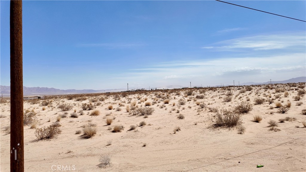 (Address is fictitious APN: 0626221460000)
Flat and buildable 0.91-acre parcel located in Wonder Valley, just north of Amboy Road on Nevada Trail. This residential lot offers expansive desert and mountain views in every direction. Zoned for single-family residential use, it's suitable for a future home, getaway cabin, or investment hold.
Electricity appears to be nearby. No water or sewer connections currently, but private wells are common in the area—buyer to verify feasibility. The property is situated in a quiet, rural setting with proximity to BLM land, providing opportunities for hiking, exploring, and enjoying the open desert landscape.
An affordable option for those seeking space, privacy, and potential in the high desert.
Bring your LandGlide App and walk along the parcel to explore the boundaries.
