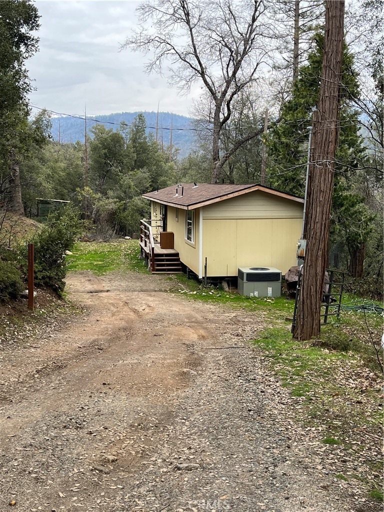Opportunity awaits in this serene mountain setting with a seasonal creek. Lovely views with mature oak and pine trees surrounded by the national forest. Shared well with 1/2 interest. Septic, power and an owned propane tank. Lots of potential to build your dream home. Property needs some cleanup. 1 bed 1 bath, 750 square foot mobile home was updated in 2020. See private remarks. On demand tankless water heater, pine cabinets and laminate flooring. Would make a great airbnb or offer a place to live as you build. Minutes from Bass Lake boat launch and 45 min. to Yosemite National Park. The mountains are calling! Call your favorite agent for a appointment.