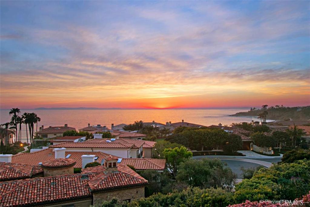 Exquisite custom home in exclusive guard gated, ocean front community of Ritz Cove!!5 bedrooms and 5.5 baths, with panoramic Catalina and Ocean views! Main floor office with full bath and walk-in closet! Home features a media room with gym area! Master suite with fireplace, retreat and extra large viewing deck! Kitchen includes hand crafted custom cabinetry with designer finishes, Viking appliances and Subzero refrigerator, breakfast nook which opens to the family room! Quality workmanship and features throughout including slab stone counter tops, designer stone and distressed hardwood flooring, quality Kohler plumbing fixtures throughout and wrought iron custom crafted stair railing!! Extensive exterior detailing with custom crafted front door and garage doors! Stunning salt water pool and spa located off the covered loggia! Beautifully designed landscaping with stone pathways and a 3 car attached garage!!