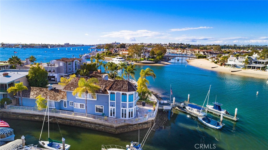 The ultimate Newport Beach address, 7 Collins Island is lucky in all respects. One of only eight homes on this unique private island at the western tip of Balboa Island, 7 Collins offers a 3498 square foot Cape Cod style home on a giant 6000 square foot lot at the best location in the Harbor. With a dazzling 150 linear feet on the water and dock space for 2 boats (one up to 70 feet long), the 1970’s era home is livable as it is or can be remodeled or rebuilt into an estimated 6800 sf home. The first floor provides a large living room with fireplace, separate sitting, dining, and kitchen areas, a first floor bedroom suite and a large garage with private driveway. The second level comprises a large master suite with its own sitting room and balcony and a 2nd guest suite. With superior views of the Harbor and Beacon Bay, 7 Collins has it all!