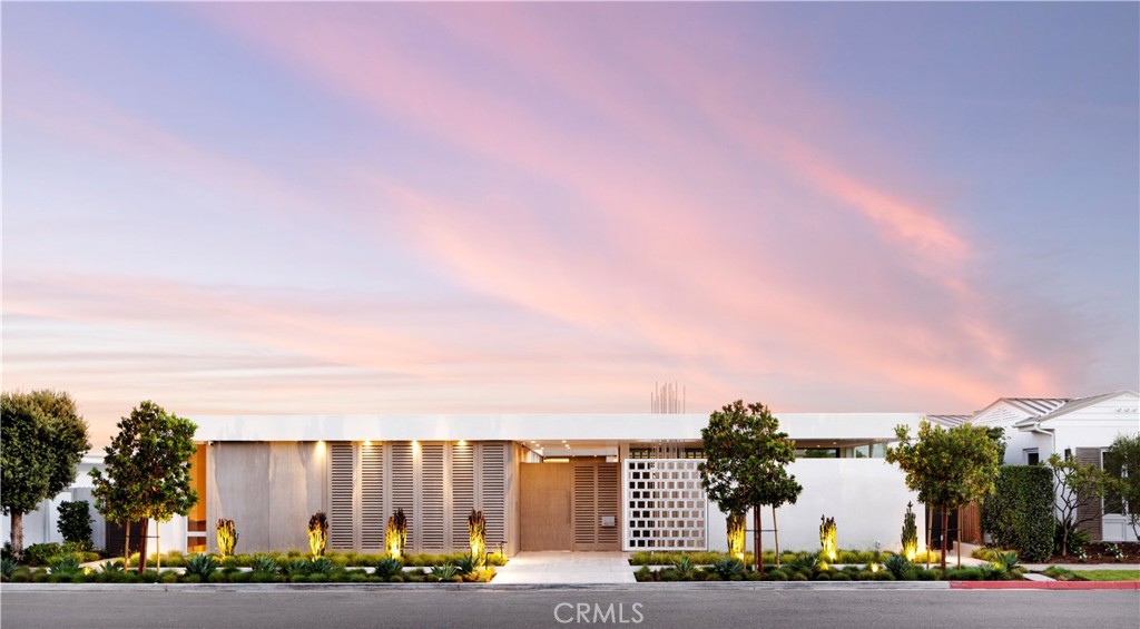 Grounded in timeless Modernism, this residence unveils a narrative of open and porous space that artfully celebrates the unity of light, air, and water. Step through the private gated courtyard, cross the bridge entry, and be greeted by a striking two-story living wall that complements the impeccably finished guest casita. Masterfully harmonizing elegance with practicality, the living areas seamlessly extend toward the fluid textures of the infinity pool, offering breathtaking views of the Pacific Ocean. Floor-to-ceiling walls of disappearing glass doors effortlessly align with marine-grade cedar cladding, expanding your living space to the outdoors. Admire Catalina Island from the private primary suite complete with a warm limestone and walnut fireplace. Extending down the hallway just beyond the artfully crafted contrasting bookcase, discover two additional bedroom suites. A spiral helix staircase descends to the lower level, unveiling a mesmerizing wall of glass showcasing yet another expansive living wall. Enter a captivating lounge with a wine wall and billiard table—a space that effortlessly aligns with the intuitive programming of the media area and the surrounding natural elements. Bask in the amenities of the wellness spa, reminiscent of a high-end resort, opening to a 900-square-foot open-air terrace adorned with a reflective pool, cantilevered stairway, and living wall. The 1,935-square-foot subterranean collector's garage provides the ability to display multiple vehicles. This residence seamlessly blends opulence with function, offering an unparalleled lifestyle that transcends the ordinary. Wellness features, including advanced air and water filtration systems, are certified by Delos™. Additionally, Cameo Shores residents enjoy gated beach access. Discover the epitome of refined living in this distinctive Orange County home—where sophistication meets innovation and every detail is meticulously curated for the discerning few.