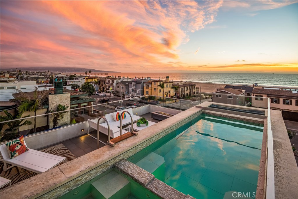 Exceptional Seaside Contemporary.
A warm approach was taken to this contemporary ocean view masterpiece. Designed by renowned architect Michael Lee and built by Kim Komick
Development. This is your opportunity to live just steps from South Bay’s finest stretch of beach with forever ocean views. Some of the custom features throughout include floating staircases, artful uses of Coral Stone on the interior, Camaru wood siding on the exterior and extensive use of distressed walnut floors. A rooftop cabana reminiscent of a world class resort leads to a pool and spa. There is a expansive use of glass to capture a lifetime of ocean views. Other features include a 4-stop elevator, motorized shades, switch back frosted glass windows in the master bath and cabana for privacy,radiant heated floors in the master bath, Fleetwood patio doors, and colored honed concrete floors in the bottom level. The chef’s ocean view kitchen includes appliance packages from Thermador and Meile. The home is completely automated with cameras and a Savant system. Included are 8 flat-screen televisions. There are 5 bedrooms and 5 1/2 Baths in app BTV. 4237 square feet of living space along with 3 ocean view decks and a ground level patio with a beach shower. The street to street lot allows for a 2-car garage and 1 parking space in the rear.