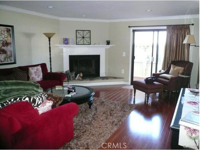 This townhouse style home features two large bedrooms, an open kitchen and dining area, living room with fireplace and two baths. There is a bonus room for either an office, gym or storage. Spacious patio for barbeques and entertaining, a balcony, wood flooring, enclosed laundry and much more. This home is charming, has many upgrades and is very well maintained. There is a gated community pool for those warm Redondo Beach days. Located close to the Beach, freeways and shopping. Very desirable area.