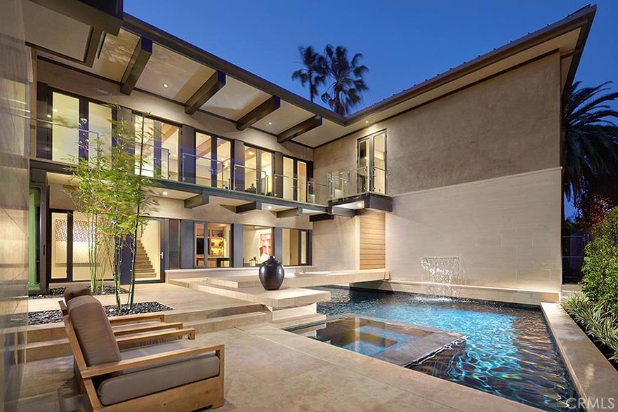 An astonishing blend of elegance & craftsmanship in this stunning 4 bedroom, 4.5 bathroom masterpiece in the gated community of Linda Isle. Using only the highest quality construction materials & with the finest attention to each detail, the estate was built by Gallo Builders & designed by architect Carlton Graham to seamlessly blend indoor & outdoor living, with each room allowing for breathtaking views of the harbor & city lights. Spanning nearly 7,000 square feet of living space & 113’ of water frontage with views toward the turning basin, the residence offers an extremely functional floor plan with large, open living spaces at the center of each floor for communal gatherings. Outdoor living areas include a private front courtyard complete with sparkling spa & swimming pool with a bridge walkway, a terrace spanning the width of the property overlooking the harbor, with access to a gangway and boat dock able to accommodate an approximately 60’ vessel. The home seamlessly merges classic architectural elements & contemporary style & design, resulting in a truly breathtaking experience. With all of its scale and grandeur, 86 Linda Isle remains warm & inviting, making it a unique retreat for intimate family life, yet poised for large-scale entertaining.
