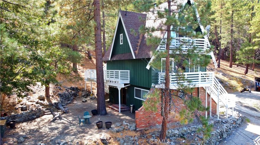 IMPOSSIBLE to find this much house for this price!  So many desirable features, plus totally AMAZING views from this charming chalet on private road near National Forest.  Check out the recent photo of deer on property! Come make this 3 BR/3BA on 3 levels your very own mountain home or escape on a full 12,000 s.f. lot!  There's room for the family, with private suite on lower floor complete with bonus room and private entrance.  Private access on two other levels as well.  Spacious great room with efficient wood-burning stove, full bath & access to front and rear decks are at mid level. Top level has 2 spacious bedrooms with attached decks, full closets and central bath.  Fresh interior paint and expansive windows all around allow plenty of natural light.  Enjoy open beams and wood accents, beautiful laminate flooring, and dual-pane windows.  Energy-efficient custom blinds keeps costs low.  Relaxation & entertainment options abound.  Experience the joys of village life with winter sports and outdoor activities at your fingertips. Two adjacent vacant lots ensure privacy and expansion & possible income options.  NOT in flood zone.  Motivated seller offers home-protection plan with acceptable offer! Virtual tour link: https://vimeo.com/768740092