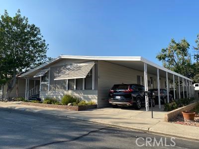 Stunning turnkey Triple-Wide home in the sought-after UPLAND MEADOWS MOBILE HOME PARK COMMUNITY. This gorgeous home has been Totally Remodeled and is almost 2000 Sq Ft of Tasteful Perfection. Wide open floor-plan with Top quality Laminate flooring thru-out, upgraded paint, baseboards, crown molding, beamed ceiling, plantation shutters, totally remodeled kitchen with high-end stainless appliances and quartz counters. Huge master bedroom and bath with step in tub and separate shower, extra room off master could be office, nursery, third bedroom, large Walk-in closet. Guest bath has been remodeled as well. Large separate laundry room with room for storage and desk area, linen closet and extra storage thru-out .
The beautiful large covered front porch area is great for entertaining and there is also room for 3-4 mid-sized cars in the covered carport area.
******************HURRY AND VIEW, THIS WON'T LAST**********************