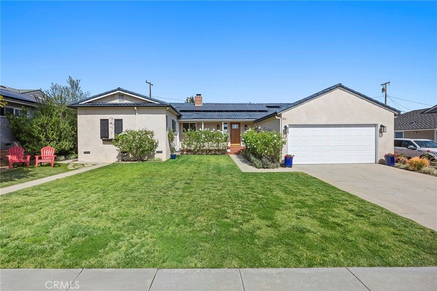 A special and welcoming home awaits in coveted Golden Hills – beautifully remodeled while keeping the original 50s charm this spacious home features stunning original hardwood flooring through the living areas and two of the four bedrooms, dual paned windows with wood clad interiors that are beautifully complimented by the custom 3 panel solid wood interior doors and casings. A generous sized entry way welcomes you inside and leads the way to the comfortable living room with brick fireplace and large windows and French door that leads out to the custom tile, covered patio. Adjacent the living room is a dining area with stylish light fixture and flows seamlessly into the kitchen. Speaking of the kitchen, it has been remodeled and now enjoys maple wood cabinets, granite counters and S.S. appliances including a built-in microwave. A bright and inviting breakfast nook and a serving buffet complete the kitchen.  On the south side of the home two very generously sized bedrooms are found with those amazing hardwood floors and matching 3 panel solid wood closet doors. The rear bedroom enjoys a French door that leads to the covered patio. Between the two bedrooms a fully remodeled bathroom is found with tile flooring, a custom shower and separate bathtub, a dual sink custom vanity completes the bathroom. Set at the rear of the home another bedroom is found with a large closet and a sliding door that leads to the backyard, this room makes an ideal home office or guest room. The primary suite is private and features vaulted ceilings and dual closets, one of them a walk-in. The en-suite bathroom has been remodeled and offers a custom vanity and tiled shower/bathtub. The private and low maintenance backyard features a large and custom tile patio that flows seamlessly out to the artificial turf lawn and a cozy sitting area with propane firepit. Mature olive and Italian cypress trees create a Tuscany like atmosphere. Multiple fruit trees, including two Meyer lemon trees are a further highlight of the yard! Tucked around the north side of the yard is a covered patio area, ideal for al fresco dining, just steps from the kitchen. Additional features of this residence are; an inside laundry room, metal tile roof, central heating and air, paid off solar and a new main line sewer in 2022!