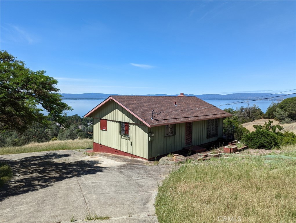 Beautiful lake views from this home in the hills of Lucerne. Up a private dirt road sits this cabin style home on 1 acre. Home could use some TLC but with the metal siding and newer roof it wouldn't take much to transform the home into a great vacation or full time home. Circular driveway leads to the home as well as the back deck where you will see an unobstructed view of Clearlake. Owner willing to negotiate furnishings as well.