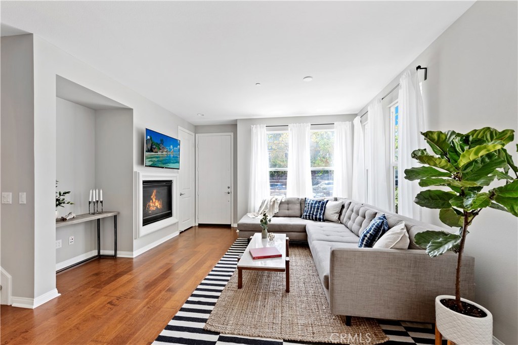 This stylish, urban and designer finished home is located in the highly sought after neighborhood of Vantis. This light and bright, 3 bedroom, 2.5 bathroom end unit is highly upgraded and updated with wide plank wood flooring, custom lighting, state of the art appliances, brand new paint throughout, a large chefs kitchen with newly refinished cabinetry and a large kitchen island. The first floor features an open floor plan with a large living room, dining room, kitchen and a powder room, as well as direct access to the 2 car garage. The second floor boasts a spacious master bedroom with a retreat and a large master bathroom with a walk in shower, soaking tub, dual sinks and a walk in closet with custom built-in’s. Also on the second floor you will find an ever popular and convenient upstairs laundry room. The third floor offers two additional spacious bedrooms, one of which also has a retreat; these bedrooms share a bathroom. This home is located within walking distance to restaurants, coffee shops, a state of the art health club and the Aliso Viejo town center. The HOA offers a pool area, a gorgeous, newly remodeled clubhouse, gorgeous walking paths and large greenbelts. With excellent schools and located conveniently close to the 73 freeway, this home is a must see.