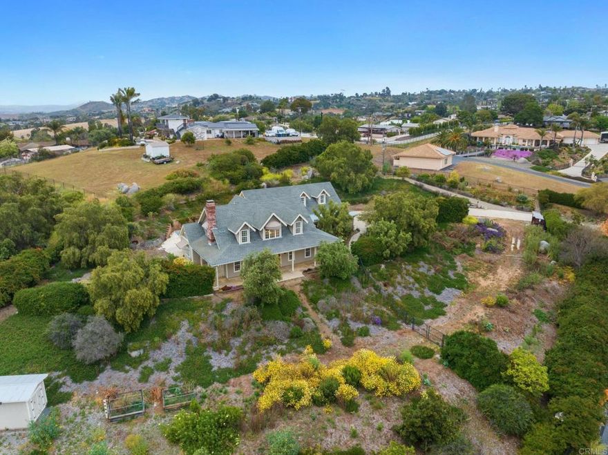 This picturesque modern farmhouse is situated in the rolling hills of Vista with stunning sunset views from the front porch and most bedrooms. This home lives like a single-story with a master bedroom suite downstairs along with a living room, dining room, kitchen and stairs that lead to two additional bedrooms and a full bath upstairs. As you walk towards the laundry room, you’ll notice where this home becomes especially unique. The property has the potential of separating the main home from three separate areas that can be converted into three units with independent entrances.