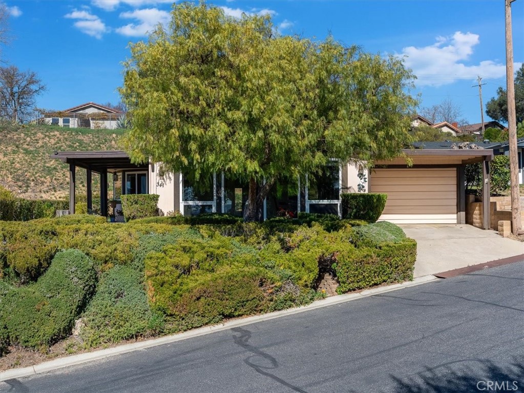 Situated near the top of the hill, this home has it all from the spacious 1960+ sf floor plan to its beautiful sunset views! It is located in one of the most desirable gated Senior Communities in the area. Park amenities include RV storage, swimming pool, hot tub, tennis, and an activity center. You will love this active adult community!