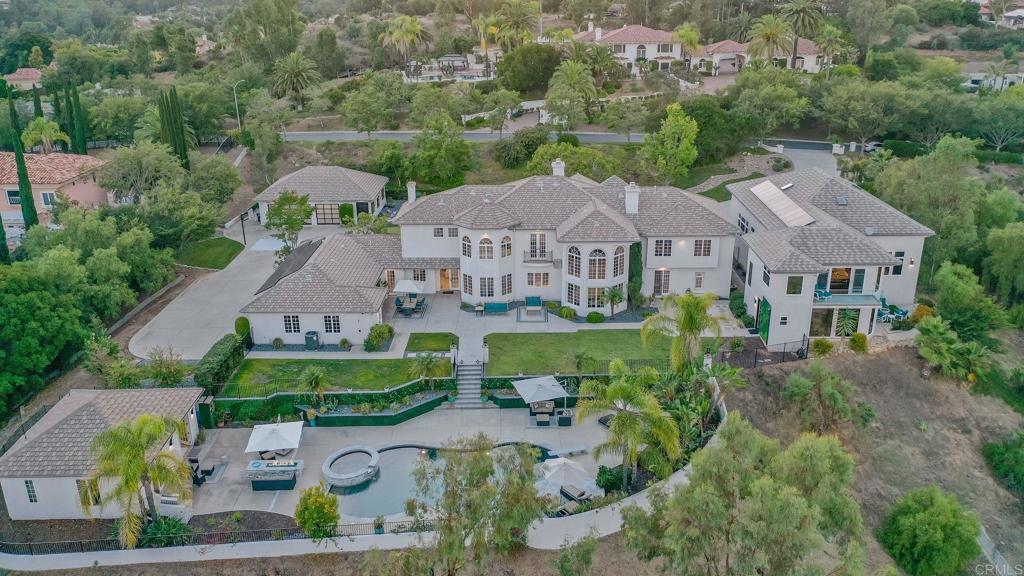 Experience the pinnacle of luxury living at 15835 El Camino Entrada, a masterpiece of architecture and design nestled in the heart of Poway, California which is known for its top-rated schools, scenic beauty, and a strong sense of community. This extraordinary estate boasts unparalleled craftsmanship, world-class amenities, and an ambiance of sophistication that sets it apart from the rest. This estate exudes a compound feel, making it versatile for various luxury lifestyles. Whether you seek tranquility, recreation, or entertainment, this property can accommodate it all. Featuring 5 ++ bedrooms, 6.5 exquisitely appointed bathrooms, 6-car garage for car enthusiasts, panoramic views of Poway’s finest attractions, and 2 usable acres. The separate pool house provides a private oasis for relaxation and entertainment. Take a dip in the pool, bask in the California sun, or host unforgettable poolside gatherings. The pièce de résistance of this estate is the world-class sports facility, complete with a basketball court featuring elite NBA material flooring and an adjacent weightlifting quarter. Whether you're perfecting your jump shot, pumping iron, or hosting a friendly pickleball match, this space is designed for athletic excellence. El Camino Entrada is truly one of Southern California's finest estates and offers the leisure to live your DREAMS.