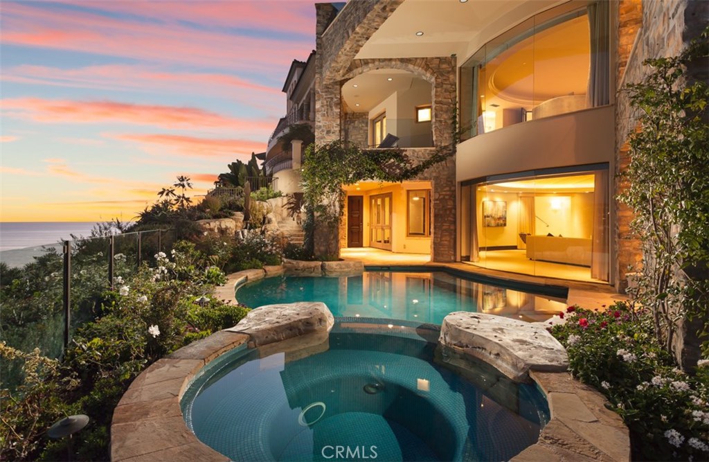 Showcasing one of Emerald Bay's finest front-row locations, this exquisite estate blends Old World elegance with contemporary flair in a grand residence that maximizes panoramic ocean views from almost every room. The impeccable seaside sanctuary rivals 5-star resort living, promising its fortunate residents a rare lifestyle complimented by a setting just above a beautiful private beach. Reflecting unparalleled craftsmanship and attention to detail, the residence encompasses nearly 5850 square feet of exquisitely appointed living space, with floor-to-ceiling windows, elegantly crafted stone flooring, voluminous ceiling heights, romantic archways and elegant wrought-iron staircases. Appreciated refinements are led by an enormous home theatre for film connoisseurs, state-of-the-art audio and lighting systems, a gourmet kitchen with Viking and Wolf appliances, temperature-controlled wine room with storage for up to 700 bottles, 5 bedrooms, 6.5 baths, a game room or formal dining room with an artisan-crafted arched stone ceiling, exercise room and a private ocean-front black-bottom swimming pool and spa overlooking Emerald Bay's private beach. Majestically situated on the bluff, the estate presents an elevator, 4-car garage, expansive homesite of approximately 14000 square feet, and a balcony, loggia or patio off most rooms for the ultimate in luxury living.