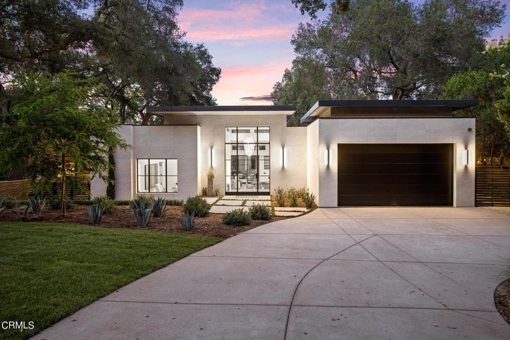 Welcome to Iron Wood. Completed in 2021 designed by Cody Elderkin of KIN Home Design & the visionary architects of IVA Design. This custom compound embodies the perfect balance of modern design while maintaining a sense of warmth & comfort and special attention to the finest finishes and craftsmanship. The 14' ceilings immediately capture the heart of the home, with the many surrounding clerestory windows adorning the spacious and open floor plan below. Massive steel windows and doors enhance the home and the 16x10 automated steel pocket doors seamlessly combine indoor and outdoor living. The sleek kitchen features William Ohs custom walnut cabinetry and Miele appliance package. The main living area features a contemporary gas linear fireplace with a plaster wall surround and a nook seating area with a large picture window. All four bedrooms are en-suite, and the main retreat has its own backyard patio access through a reverse pivot steel door, Porro Custom Italian Closets and the bathroom features separate vanities with Venetian plastered walls, 6'soaking tub and a large steam shower. The landscape, designed by Maria Newton, has entertaining in mind with a large pavilion directly off the main living area with skylights, overhead lights and a custom wood ceiling. Additionally, there is a 618 SF pool house with bifold steel doors opening to a zero-edge pool and a sixteen-person jacuzzi, a sunken fire pit with seating, a Bocce ball court, and more. This is the ultimate dream.