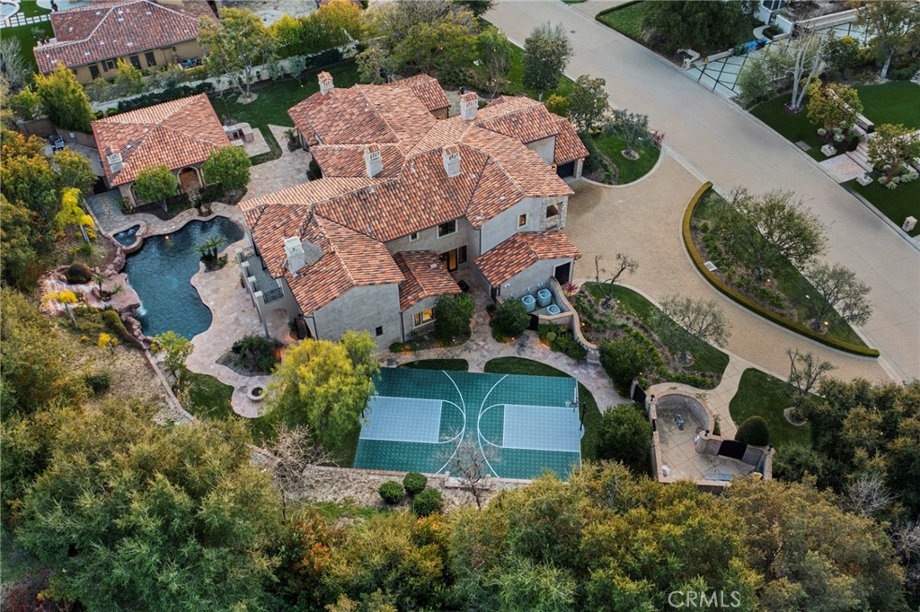 Nestled within the prestigious guard-gated community of The Estates of The Oaks this Tuscan Villa stands out among the exclusive residences in this high-end community. Boasting charming curb appeal and a wealth of luxurious amenities, it beckons those with a discerning taste for the extraordinary.
A grand beach entry pool and spa adorned with multiple cascading waterfalls, a basketball court, and a barbecue center set the stage for leisure and entertainment in the expansive private lot. At the end of a cul-de-sac, this residence ensures exclusivity and privacy in a coveted location.
The main house, thoughtfully designed for both comfort and style, features a gourmet kitchen with a central island that effortlessly connects to the spacious family room. A formal dining room with a wine cellar, a sunny breakfast room overlooking a serene patio, a finished library, and a main floor secondary primary suite add distinctive touches to the living experience.
The primary suite, a true sanctuary, encompasses a retreat, fireplace, his & her baths, steam shower, custom closets, and a view balcony, providing an indulgent escape. Wood and stone floors, a circular drive, a 4-car garage, and lush landscaping enhance the property's allure. In addition to the main residence, a fully equipped guest house provides a private retreat for visitors.
Presenting a rare blend of sophistication and comfort, this Tuscan Villa defines luxury living among the elite in high-end real estate. For more information or to schedule a private viewing, contact us today.