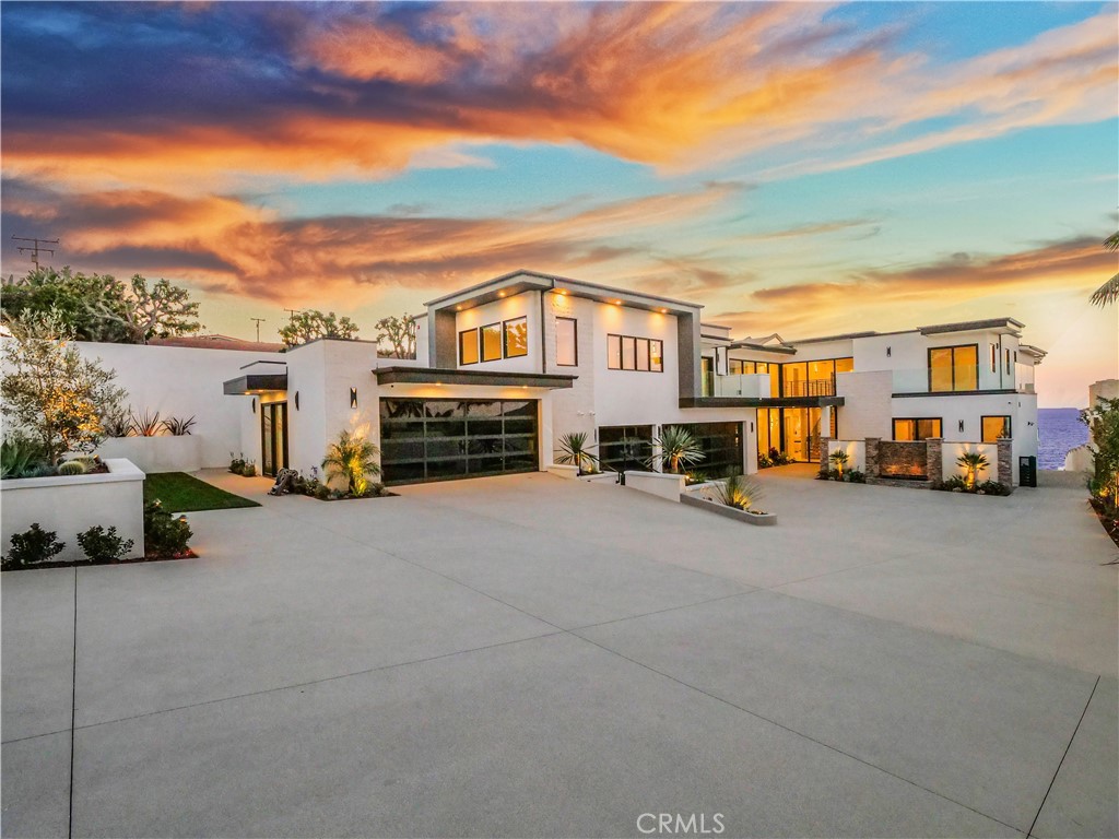 GATED ESTATE on the bluff overlooking the Pacific Ocean and coastline of the Santa Monica Bay to the North and Palos Verdes Estates looking to the South. A rare opportunity to own one of the very few homes with private beach access and a swimming pool overlooking the Pacific Ocean with an outdoor grill area. Newly remodeled pool and newly remodeled residence that has just been completed in 2025. The Living room is a large open design overlooking the pool and coastline. A custom bar area is situated to take advantage of the ocean views or television viewing area. There are 7 bedrooms with ensuite bathrooms, one of which can be used for an office. Two large laundry rooms (upstairs and downstairs), one which has a custom doggy bathtub. The kitchen is a modern contemporary open design with a butlers pantry which includes everything for cooking, food prep and pantry storage. The primary suite is too magnificent to describe. The size of the primary suite is Grand (approx 1200 sf) with a living room off the bedroom, fireplace, powder room, a steam shower big enough for the whole family (including the dog) and you have an unbelievable view of the ocean and coastline while brushing your teeth. Seriously, it will make you smile just to stand in the bathroom. There is a large Theatre room which can also be used as a gym or playroom. Garage #1 will accommodate 3 cars and garage #2 can accommodate 2 cars or be a play room, gym, or something of your liking.The house has a Control 4 automation system that allows you to connect virtually to all the automation in your home, including audio, lighting, and climate control. Where else can you find a home where you can park up to 18 cars inside the gated property? Don't worry about getting up and down the stairs, there is an elevator too! The house and entire property has undergone a complete transformation and remodel which is being completed in January 2025. Ready for showings now by appointment only.