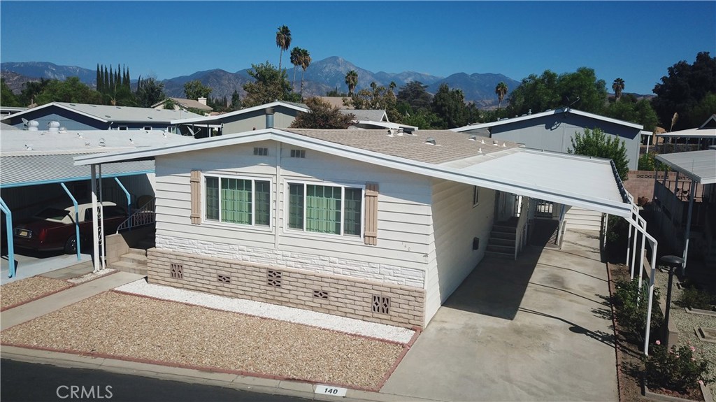 CLEAN 55+ mobile estate community. This well-maintained home with attention to detail throughout offers views of the mountains and beautiful natural lighting. Features an open concept living room and a large dining area with built in buffet and cabinetry. The kitchen features include skylight, newer cabinets and countertops with farm style sink and easy flow to the laundry/storage area and back door. The 3 bedrooms are roomy with large closets. One room has a skylight to allow for more natural light. Another room features a fireplace and a separate private entry from the covered front patio. Covered carport is wide enough for large vehicles and has a well-placed wide ramp to the back door. Private fenced backyard is low maintenance with drip watering system. Clean 6' X 8' storage shed with sturdy wood floor is located between carport and backyard. Home is located close to visitor parking and amenities which include clubhouse, pool and community green spaces with barbeque area. Maintenance/safety/upgrade records come with the sale of the home. Schedule your viewing of this move in ready home today.