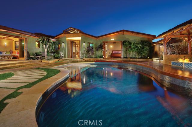 Nestled atop Irvine Terrace bluff, this spectacular 4-bedroom/5-bath custom-estate offers 250-degree panoramic views including Newport Harbor, Balboa Island, and Catalina vistas extending from Newport Coast to Long Beach. Upon passing through the teak gate and travertine wall entry, guests are transported to a tropical setting and drawn to the focal point of the striking interior courtyard, the pristine black bottom pool, beach landing and guest casita. As guests enter the home, the view unfolds itself and light spills over the impeccably designed Great Room, complete with custom furniture and sand-blasted cathedral wood ceilings. The open floor plan reveals the chef’s kitchen with designer appliances and a tasteful blend of contemporary finishes and Old World craftsmanship. The Master Suite offers unobstructed, lay-down views and an exquisite master bath with Swedish dry sauna, Japanese soaking tub and river rock bottom, walk-in shower. The remainder of the home includes the four, expertly-designed bedrooms –all with en-suite baths – and a separate office. Views abound from the resort-style, 2,000+-square-foot backyard, complemented by the infinity Jacuzzi and palapa-covered kitchen with Italian wood-burning stove, bar and TV.