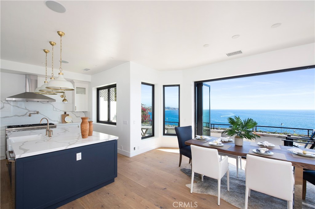 Renovated with the most current design trends for a fresh Coastal Modern aesthetic, 107 S La Senda presents a like-new oceanfront estate with panoramic vistas of the rugged coastline all the way to the Dana Point Headlands. The south-facing residence welcomes all-day sun to further enhance the light and bright design which encompasses 4 bedrooms and 4 baths on the upper level, and an open-concept lower level consisting of a gourmet kitchen, dining area, bar and great room – all of which flow to a wrap-around patio providing the highly-coveted indoor-outdoor lifestyle. Art-like fixtures and finishes are found within the space, including Calacatta marble countertops, Calacatta Oro backsplash, chic designer lighting and brass hardware set on crisp white and contrasting blue cabinetry. A built-in wine refrigerator and walk-in pantry with hand-painted floor tiles are evidence of the attention to every detail deployed by Becki Owens in the design process. Upstairs, each space is flawlessly appointed utilizing a mix of texture, color and premium materials including white quartz, open wood shelving, herringbone tiling and beautiful sage-colored cabinetry, to name a few. Crowning the estate is the master suite, complete with fireplace-warmed seating area, walk-in closet, stunning master bath, and two decks overlooking turquoise seas. Set behind the guarded gates of Three Arch Bay with access to incredible community amenities, there is no better place to call home.