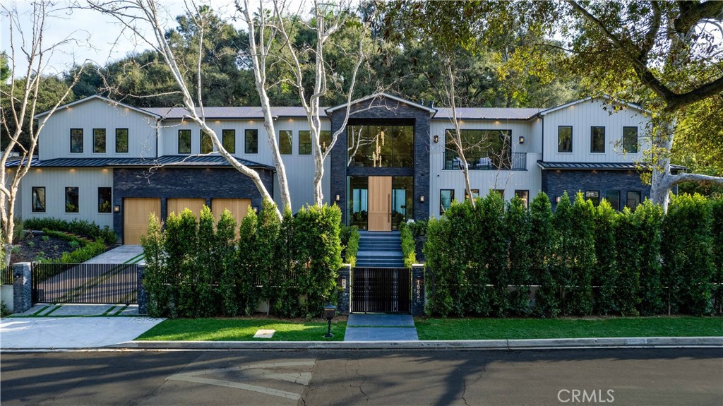 New custom estate on a prestigious street in the highly coveted Royal Oaks neighborhood of Encino - enveloped by oak trees providing privacy and a feeling of secluded nature. Featuring 6 BR – 11 BA, office, gym, and home theater in over 12,000 sq ft on an almost 40,000 sqft wide, gated lot with tall trees for privacy. Expansive gourmet kitchen features Taj Mahal quartzite countertops, two islands, breakfast nook, custom cabinetry, Wolf appliances including espresso maker, walk-in pantry, and full secondary kitchenette. Family room features custom built-ins, two-way fireplace with porcelain slab accent wall, and sliding doors to covered patio area. Bright dining room features wet bar with seating, wine refrigerator, and walk-in wine display with accent lighting. Adjacent formal living room features two-way fireplace and sliding doors to yard. Second wing features den area with wet bar and sliding doors to yard, en-suite office with custom built-in, en-suite gym with floor-to-ceiling mirrored walls, and home theater with custom built-ins. Spacious and serene yard features stunning modern pool/spa and resort-like amenities such as firepit, BBQ area with bar seating, custom water feature, basketball hoop/sport court, and oak-lined hillside highlighted by accent lighting. Staggering primary suite of over 1,300sqft features high, pitched ceiling, custom accent wall, seating area with built-ins/fireplace and balcony, and second balcony/deck overlooking yard and oak hillside. Main primary bath features marble flooring/ceilings, vanity with bulb-lined makeup mirror, and steam shower with porcelain slabs. Expansive primary closet area features two walk-in closets with islands and accent lighting, and spacious secondary bathroom. Home is completed by entertainer/designer details such as custom woodwork/tilework throughout, floor-to-ceiling windows, upstairs den area with fireplace, elevator, spacious secondary en-suite bedrooms, two powder rooms, three-car garage with wide driveway for additional parking, surround sound speakers, Control 4 smart home system, and security system with alarm/cameras. Truly a must see to take in all this stunning home has to offer!