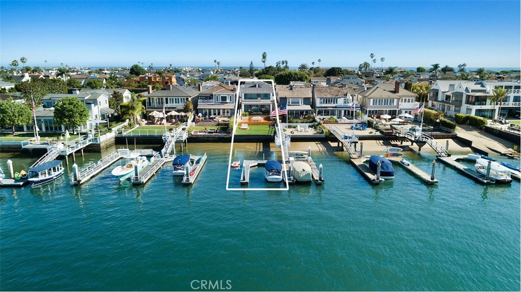 Light-infused contemporary architecture meets unparalleled bay front living at Balboa Peninsula Point’s most coveted address: East Bay Avenue. With a clean design aesthetic and an air of understated elegance this heirloom home on Newport Harbor is highlighted by engaging water views and inviting living spaces. Gutted-to-the-studs and completed in 2017 the spacious four bedroom, three and one-half bath home is accented by warm French oak flooring, custom stonework, and a soothing color palette that lends itself to a relaxed waterside lifestyle. From the dramatic light-filled entrance to the progression of open-format living, dining, kitchen and family room spaces the interior flows seamlessly to the exterior. Stunning floor-to-ceiling walls of glass open to a spectacular outdoor dining terrace and an unusual deep bay front grassy yard. Ascending the modern cable staircase to the second level the master retreat with adjoining spa-inspired bath boasts panoramic harbor views. Adjacent to the master suite resides three thoughtfully conveyed guest accommodations. Sited on one of the most preferred locations on the bay front, with captivating water and city light views that are unobstructed by vessel moorings, the home enjoys a private dock for craft of approximately forty-five feet and Duffy side tie. An incredible opportunity to enjoy the bay front lifestyle in a newly reconstructed turn-key home.