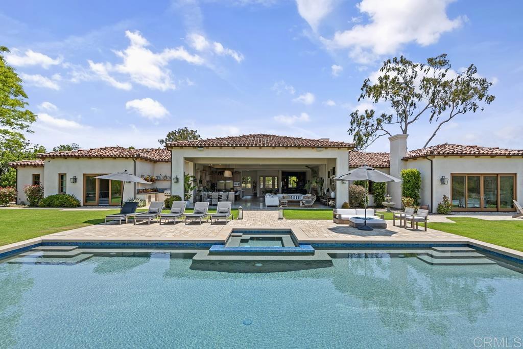 With artful simplicity and functional elegance, this single-story Richard Doan built estate is the epitome of luxury open-concept and indoor-outdoor living. With floor to ceiling disappearing windows, an expansive vanishing edge pool along with heated patio with plenty of room for entertaining family and friends. Spaces are fluid yet well defined and equally welcoming for elaborate gatherings or cozy solitude. The gorgeous detached guest house offers the ability to gracefully integrate multi-generational living or business headquarters into the picture too. Horse trails at the back of the fenced 2.46 acres, Rancho Santa Fe Golf Club just up the road, along with just a three minute walk to trails, means ideal location is part of the package too. Now more than ever, home is more than a place; it’s a partner. This partner is designed to support seamless integration work & rest, connection & reflection, technology & nature — the full spectrum of your life.