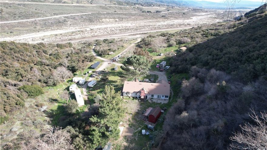 Prime Land is ready for you to unlock the potential of this expansive 40-acre lot in San Bernardino! This rare offering presents a 3+2 house, with new windows and exterior textures and paint. Oversized Solar Panel Incredible opportunity for investors, developers, or those seeking a private retreat. It is 40 acres of versatile land, providing ample space for residential, agricultural, or commercial development.  Zoning is R-R and can change the zoning on anything over 5 Acres. Ideal for a variety of uses—explore possibilities for single-family homes, multi-family units, or commercial projects. Enjoy breathtaking views and the tranquility of open space, perfect for creating your own paradise or investment opportunity.  Utilities are connected and in proximity to expanding utilities, making development easier and more efficient.  This expansive land is a blank canvas awaiting your vision! Contact us today for more information and to schedule a viewing of this incredible 40-acre property at 16397 Cajon Blvd. Don’t miss out on this unique opportunity!  Close to the Railroad tracks. There are two entrances from the main road to get to the property. Glen Helen Rd and Kenbrook Rd off Cajon.  Just notified there are plans for a shopping center approx 30 acres in the area.