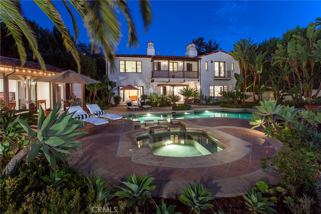 Nestled in the hillside at the end of a cul-de-sac, this Santa Barbara style estate enjoys the luxury of privacy on a 21,800 square foot lot. Surrounded by lush landscaping including majestic Canary Island date palms and views of the Pelican Hill golf course, Crystal Cove State Beach, and Catalina Island, this coastal residence exudes a serene ambiance and great Feng Shui.
The gated entry opens to a welcoming courtyard with shaded loggia and fireplace and access to a large executive office. This home has one of the best layouts with six generous en-suite bedrooms and two half baths. The main residence offers one guest suite on the main level and master suite plus three additional bedrooms and two bonus rooms on the upper level. The resort like backyard features a pool, hot tub and a large pool house with kitchenette & full bath perfect for entertaining and family gathering or the lucky house guest. Separate BBQ pavilion for enjoying al-fresco dining while admiring the stunning sunsets.
All this in the prestigious guard-gated enclave of Crystal Cove with its world-class community amenities that include the Canyon Club with tennis, swim, and fitness, parks and playgrounds, hiking trails, and easy access to acclaimed dining and shopping at Crystal Cove Promenade and Crystal Cove State Beach.