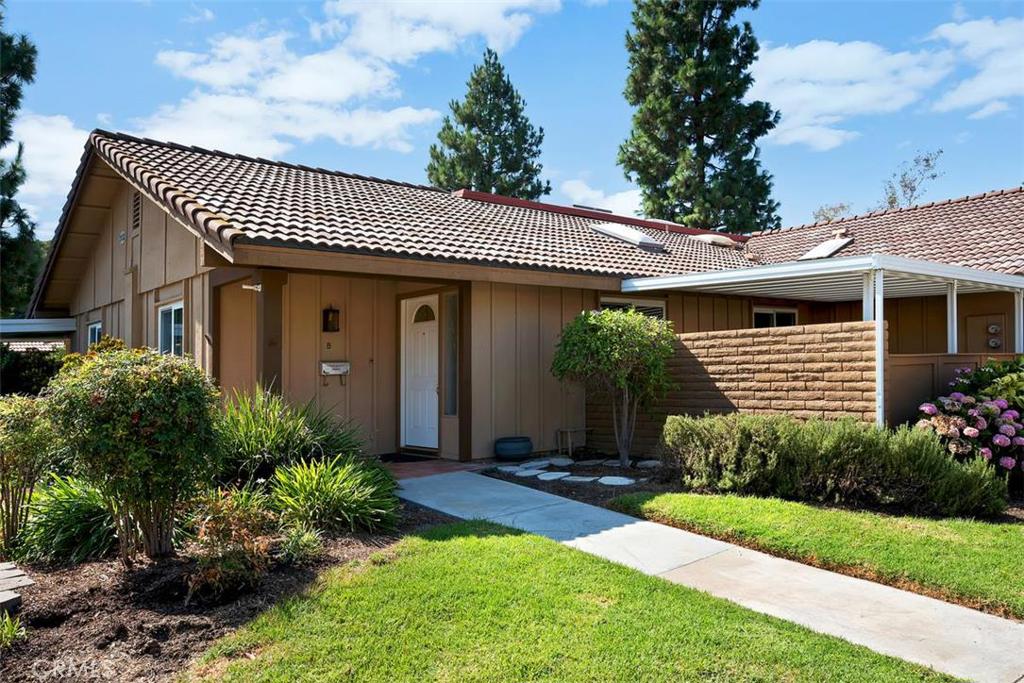 Very desirable single level Ventura model with direct access from the carports. This four unit condominium building is surrounded by a nice greenbelt and is conveniently located close to gate 8. The home has been freshly painted and features 2 bedrooms, 2 bathrooms, laundry area with side by side washer and dryer (included), newer windows, scraped/textured ceilings, crown molding, skylights in the kitchen, dining area and living room, solar tubes in each bathroom, ceramic tile in kitchen, bathrooms, laundry and dining areas, laminate flooring in bedrooms, and carpet in living room. Additional features include a covered patio with ceramic tile, new dishwasher, and central heating and air. Take advantage of the many amenities Laguna Woods Village has to offer including golf, tennis, swimming pools, and many clubs and social activities. It's centrally located close to shopping and restaurants.