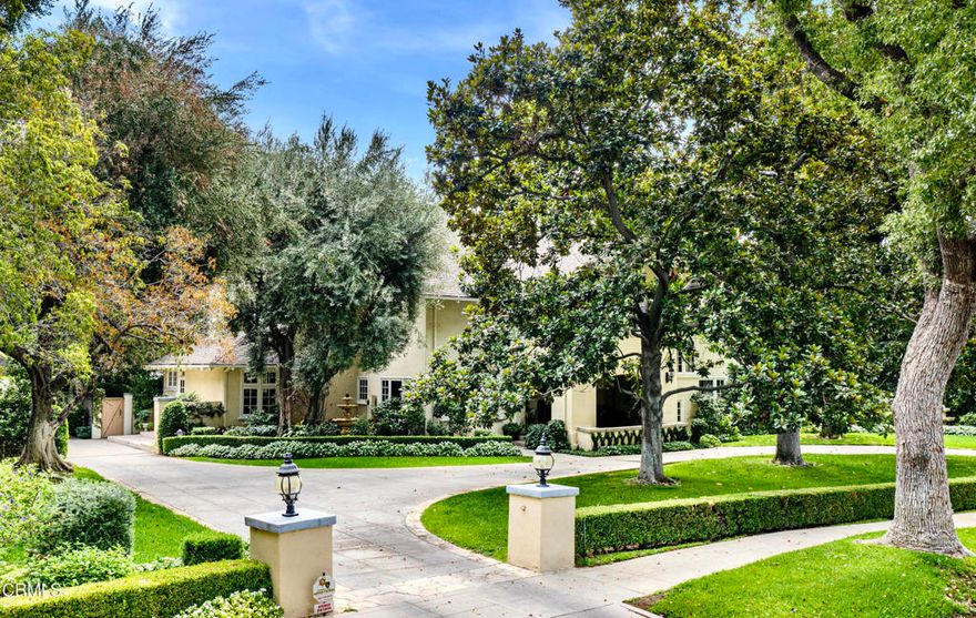 Set in the prestigious Langham area of Pasadena, this English Manor estate by architects Forman and Martin achieves a timeless elegance rarely seen. Built in 1914, this stately home stands on 0.66 acres of manicured grounds, complete with a secluded backyard pool and spa, outdoor kitchen and patio, and a generous motor court with 3-stall garage. A grand foyer welcomes you into the over 6,000 square foot interior, where richly coffered ceilings drape above detailed woodwork, and glass sconces adorn the walls. Architectural details continue through exquisite entertaining spaces including a parlor, formal dining room and a formal living room with a fireplace and ornate mantle. The gourmet kitchen with custom carved wood cabinets is equipped with a cooktop center island, extensive windows and storage, a butler's pantry, and eat-in space for casual dining. Seamlessly transition to the backyard terrace to grill and dine al fresco with guests beside the pool, or retreat to the main-level study to reflect by the fireplace surrounded by floor-to-ceiling bookshelves. Upstairs is the luxurious primary suite with a walk-in closet, en-suite bath and oversized corner tub overlooking the serene exterior. Secondary bedrooms, two additional full baths, and a private balcony extend throughout the upper floors, while the lowermost floor features a large multipurpose room with a fireplace and abundant storage. All within moments of local dining and amenities, freeways and historic landmarks, this impressive estate is full of character and on the market for the first time in over 40 years.