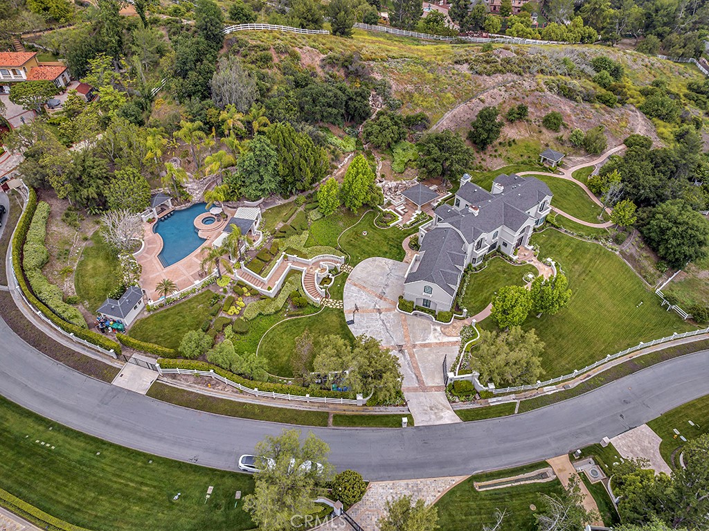 Look no further than 31752 Secoya Way for a stunning 5.8 acre estate with equestrian space, multiple outdoor entertaining areas, a resort style pool/spa overlooking the estate and Coto de Caza's amazing views. Make your way through the front door to two-story ceilings adorning the formal living room that showcases a floor-to-ceiling fireplace and an abundance of natural light. The recently remodeled gourmet kitchen features top of the line stainless steel appliances including a Sub-Zero wine fridge, 6-burner Wolf range with double oven, two dishwashers, two large islands and beautiful gold fixtures that compliment the leathered solid white marble counters and white cabinetry. Just off the kitchen is the family and dining room, and a laundry room that is conveniently located near the bottom of a second staircase that leads you to the massive bonus room/game room that is equipped with a wet bar, and a perfect retreat for entertaining. Two guest bedrooms, a private office and powder room complete the main level. Upstairs, you'll find the stunning resort-like Primary Suite with a marble fireplace and a luxurious marble en-suite with its own private balcony. Down the hall are three secondary bedrooms with en-suites, and a reading nook overlooking the beautiful landscape. A private gated entrance and long driveway leads you to the 3-car garage. Located in the Los Ranchos Estates of Coto de Caza, this is truly a picturesque property you will need to see to believe.