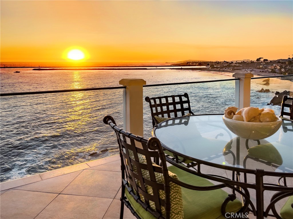 Offered for the first time in decades, this oceanfront residence occupies the premier location on the famed Ocean Boulevard in Corona del Mar. Set at the quiet southern end of the boulevard and across from the pedestrian path to Little Corona Beach, the seaside property has 180 degree unsurpassed views of the ocean, Catalina Island, Newport Harbor, whitewater, coastline and sunsets. Located on street level, the spacious primary bedroom suite with fireplace features sliding glass doors opening onto the expansive oceanfront deck overlooking the commanding views. An adjacent elevator services all three floors. The mid level, graced by flowering trumpet vines offers a private Dutch door entry - opens to welcoming soft ocean breezes and mesmerizing views of the ocean. The elegant living room and dining room complemented by oak plank floors, stone fireplace, floor-to-ceiling windows and retractable doors flows onto the outdoor deck - perfect for year round entertaining. The well appointed kitchen and adjacent breakfast nook offers dramatic ocean views. Lower level hosts two secondary bedrooms with sliding glass doors opening onto the viewing deck, an office (which could be a fourth bedroom) and a laundry room. Convenient on-grade two-car garage with side-by-side parking, and a driveway accommodating four cars. The pedestrian-oriented lifestyle enjoyed in Corona del Mar includes days on the beach, walks through the tree-lined streets of the village, fine dining, quaint shopping and easy access to the very best amenities. This is the quintessential coastal Southern California seaside home.