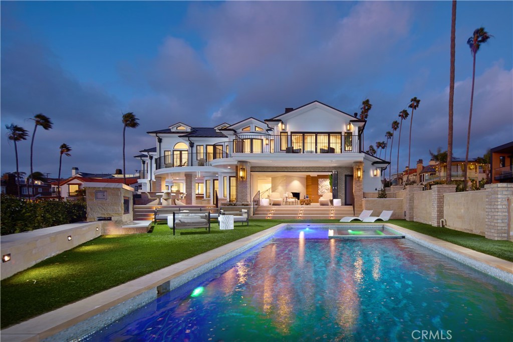 It is a rare moment when life presents the opportunity to truly have it all, and when it does, don’t let it pass you by. Welcome to Island House in the vibrant Village of Corona del Mar, where a one-of-a-kind setting, phenomenal ocean views and luxurious upgrades unite in creating one of Southern California’s most sought-after residential offerings. Embraced by an unparalleled homesite that extends nearly 11,896 square feet and combines three lots with no adjoining properties, the elegant Eastern Seaboard-style estate occupies an island with appx. 276' of frontage on Ocean Boulevard that welcomes sweeping views of the Pacific Ocean, Catalina Island, Lookout Point Park, The Wedge surf break, Newport Harbor, the Balboa Peninsula, city lights, Palos Verdes and unforgettable sunsets. Designed by award-winning architect Brion Jeanette and built by Finton Construction, the residence encompasses seven en suite bedrooms, 10 baths, a third-level game room with open-air deck, loft, dual offices, basement media room with glass-enclosed appx. 650-bottle wine cellar, 15-seat home theater with oversized screen, formal living and dining rooms and two wet bars in approximately 7,168 square feet. Traditional and contemporary design complement one another in the home, which was completely reimagined and luxuriously enhanced in 2018. Cook and entertain in a fabulous kitchen that hosts a massive island, European-style wood cabinetry, marble countertops with backsplashes that reach the ceiling, and high-end appliances. Gorgeous views are enjoyed from most rooms, including a primary suite with vaulted wood ceiling, wraparound ocean-view deck, sitting area, freestanding tub, separate shower, and dual vanities. Noteworthy refinements are led by white cross-beam ceilings, contemporary Circadian LED lighting, Fleetwood windows and doors, premium audio/tech systems, and Delos Wellness home design that incorporates air and water systems. Mere minutes from China Cove Beach, Village shops and restaurants, award-winning schools, scenic parks and Newport Bay, the alluring estate displays upgraded grounds distinguished by a resort-caliber pool and spa, stone fireplace, putting green, large circular bar with BBQ, and ample room for large-scale gatherings.