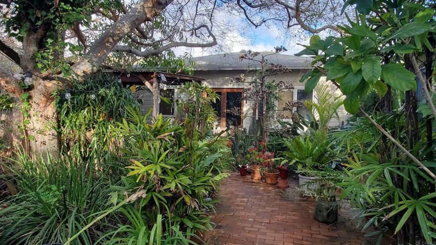 Build your dream or remodel the existing structure(s). Enjoy Rancho Santa Fe schools and living without the HOA and Art Jury. All your plans go through SD County. Sewer already brought to property. Flag lot. Current home is hidden up long driveway beneath an island of trees. A rare and valuable find, this property represents a blend of historical charm and modern potential, making it a diamond in the rough for the right buyer.   The two-bedroom home was built in the 1940s and includes a detached 2 car garage with a studio apartment including walk in shower and kitchenette plus an additional finished room currently used as an art room. The lack of an HOA and Art Jury is a significant advantage for many buyers, as it allows for more freedom in terms of property use and modifications, without the additional fees and restrictions that can come with HOA governance. This site would be a prime candidate for re-development into your dream home and private resort just 10-15 minutes to the freeway, shopping, and beaches. Location, location, location!  • No HOA Restrictions or Fees: Freedom to use the property as you see fit, from architectural designs to landscaping, without needing to conform to stringent community rules or paying monthly fees. • Potential for Customization: With the only requirement being obtaining permits from the County of San Diego, the process of building or modifying the property may be more straightforward, allowing the owners to bring their visions to life more easily.  • Historical Value: Being part of an original homestead from the 1850s adds a unique historical and aesthetic value that can’t be found in newer developments. • Natural Beauty and Privacy: The 2.4-acre lot filled with mature trees offers a serene and private environment, ideal for those looking to escape the hustle and bustle of city life without being too far removed.  • Versatile Use: The possibility for horses, tennis courts and other recreational facilities can make this property a personal retreat tailored to the owner’s hobbies and interests. • Desirable School District: Highly sought after Rancho Santa Fe School district is a significant advantage for families.