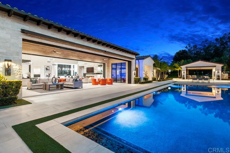 This truly one-of-a-kind custom estate has a total under roof square footage of 13,844 including main house and other structures and was just completed in 2019 by a renowned team of top professionals: Architect Mark Radford, Builder Paul Munsch, and Designer Maria Barry. Located on an exceptionally private 2.7-acre parcel on the west-side of the Rancho Santa Fe Covenant, this Estate genuinely sets a new standard for luxury in Rancho Santa Fe. At every turn, this Estate exceeds expectations with unparalleled construction quality, exquisite upgrades, elegant design, and impeccable attention to detail.    This gated Estate consists of a 4-bedroom main residence, generously-sized indoor-outdoor covered veranda, resort-style pool, detached guest house, pool cabana, professional car-collector garage, 3-par-custom-designed-golf-fairway, and a 66 panel solar array with backup Tesla battery and backup system.    The main residence, in addition to its 4 bedrooms, consists of an office, theatre, and a seamless indoor-outdoor home design complemented by two sets of automatic 42-ft lift-and-slide pocket doors that effortlessly blend indoor and outdoor living spaces. This home also has the conveniences of modern technology with a Crestron system with countless upgraded functions including a comprehensive Lutron lighting system, interior and exterior power shades, security cameras, as well an expansive sound system. Practical amenities such as UV Ray window tinting, a Flo-Logic Leak Detection, and Shut off System ensure utmost comfort and security.   The Estate also redefines multigenerational sophisticated living. The detached Guest House consists of a generous bedroom, over-sized resort bathroom, family room, kitchenette, covered veranda living, plumbing provisions for both a stove and washer/dryer, and an attached two car garage.    The free-standing entertainment Cabana is perfectly situation perched between the resort pool and the 3-par golf course. The Cabana captures the essence of indoor-outdoor living with 3 frameless glass bifolding door systems, a highly upgraded interior, and a sunken bar, with entertainment wall.     The golf course was specially designed by Paul Munch with 6 tee boxes, two greens, to enable a golfer to have 18 different shot selections. The course was landscaped with Synlawn Turf, numerous bunkers, as well as a custom Verdin Starters Golf Clock.    Car collectors and enthusiasts will revel in the Estate's separate motor court with a separate custom 8-car professionally designed Car-Collector Garage featuring pre-wired options for an additional six auto lifts, custom-sized garage bays, automatic custom shades, power security shades and security system, and advanced door motors with remote power kill switch functionality.   Exemplifying meticulous attention to detail and unparalleled elegance, this extraordinary Estate sets a new standard for luxurious living in Rancho Santa Fe Covenant.