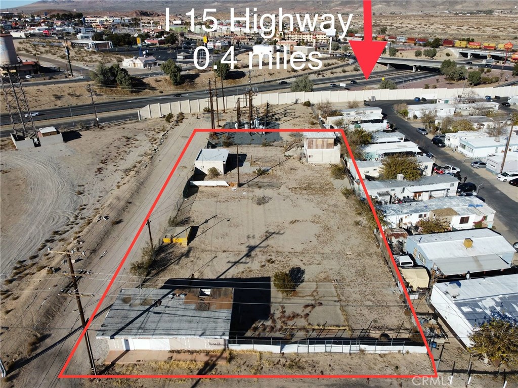 THREE STRUCTURES on 30,000 sq. ft. lot. Approximately 900 sq ft was used for residential. Approx. 800 sq ft building can be used for office/industrial with approximately 900 sq. feet of garage space. Electricity on at unit 1 and unit 2. Unit 3 had a small fire and is red tagged. Has 1 water meter that's operable. Sewer is hooked up. Located within Opportunity Zone!!! Subject to cancellation of current escrow.