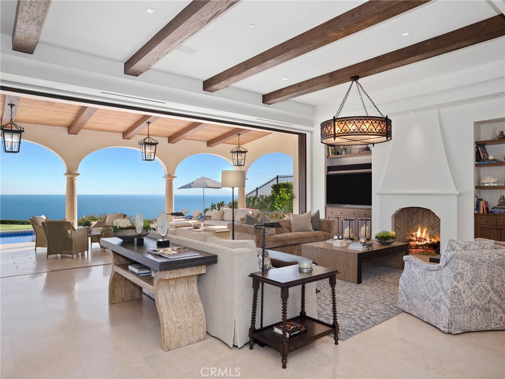 Cresting high above the blue Pacific in the prestigious enclave of Crystal Cove, this exquisite estate blends front-row ocean and coastline views with impeccable design to create an unparalleled living environment. This Spanish Revival residence was granted a rare 30' height allowance, creating a commanding street presence and a more stately stature. Grounds feature 2 courtyards, raised vegetable gardens, a 42’ pool and spa with built-in swim jet system, an entertainment pavilion with fireplace and an outdoor kitchen with pizza oven. A pathway connects the outdoor kitchen area to an al fresco dining area creating a tranquil ambiance with incomparable coastline views. Equally impressive, Transitional-style interiors reveal 5 en suite bedrooms, 6 full and 3 half baths, an office and a guest casita. Even the most demanding chefs will feel at home in a kitchen with 2 islands, Neolith countertops, a butler’s kitchen, top-tier appliances, and an ocean-view breakfast room. Five-star accommodations await in a master suite with ocean-view deck and disappearing pocket doors, a sitting area with fireplace, walk-in closet, soaking tub and separate shower. An elevator serves all levels, including a lower level with theater, wine cellar, exercise room, steam shower and bathroom, sunlit lower courtyard, and a 3,000 square foot garage with 8 to 10-car capacity. This estate was designed and developed by the world-class team of Oatman Architects, Pridemark Construction and DeJager Design.