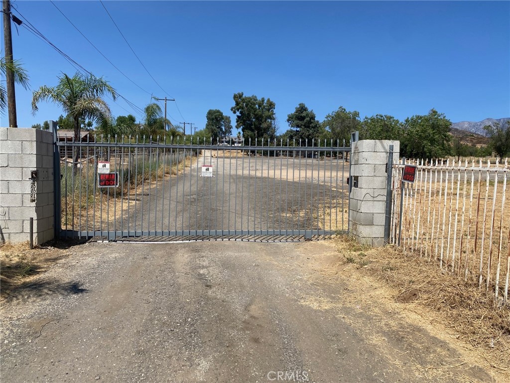 Substantial price drop! This unique Cherry Valley ranch is 7.29-acres with flat usable land for horses, pets, RVs and so much more. Two homes on a single large parcel with a gated entry from Cherry Valley Boulevard for privacy and security. The main house is 2,405 square feet per assessor's records and has 3 bedrooms and 3 baths downstairs and two additional bedrooms with half-bath upstairs. The main house features updated central heat and air, hardwood floors, rock fireplace in living room, separate dining room with double doors, nook off the kitchen, family room with wet bar, and large game room with vaulted ceilings and freestanding wood stove. The rear guest house is a manufactured home, approximately 1,200 SF, with 3 bedrooms and 2 baths. The guest house is currently rented on a month-to-month basis at $1,600 per month - so please do not disturb tenants. The main house sits back from the street and atop a peaceful knoll with views overlooking the property and surrounding community. Private well for water, which was recently updated with new pump and related equipment. There is so much potential here to create your own private compound. Great opportunity to subdivide with minimum lot size of one acre (check with the Riverside County). Owner may carry with good downpayment.