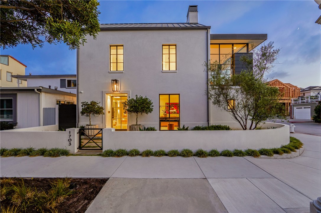With bespoke finishes, exceptional craftsmanship, and striking architectural design this stunning seaside custom home in the Balboa Peninsula Point neighborhood of Newport Beach embodies a fusion of classic modern farmhouse design and luxury. Positioned on a premier ocean-view corner lot, the stunning construction features clean lines, expansive windows, a creamy, hand-plastered exterior, and a dramatic standing-seam pitched roof. Constructed to harmonize with the environment the home is bathed in light, offering a panorama of views and a seamless connection between indoor and outdoor living spaces. Designed with an open-plan layout the home’s meticulously tailored finishes include Riviera Bronze windows and doors, antique brass fixtures and fittings, artisan lacquer paint, polished concrete, marble, and fine European woods. The state-of-the art kitchen outfitted with professional grade appliances, impressive, bleached walnut custom millwork, and a large walk-in pantry, serves as the hub of the home and allows for seamless large-scale entertaining. Blending style, comfort, and function the generous three bedroom plus den floor plan spans three levels, embracing an open concept living experience enhanced by elevator access. With a strong connection to the water, the ocean view roof top terrace enjoys an ever-changing landscape of sunset and surf break views and is the ideal spot to enjoy a glass of wine around the fire with family and friends. Smart home technology, advanced lighting, climate control, and security and surveillance systems, automated window treatments, an elevator, two laundry areas, and an oversized three car garage are additional amenities of the residence. Combining architectural sophistication with thoughtful functionality this stylish ocean-close home affords a timeless and inspiring lifestyle experience.
