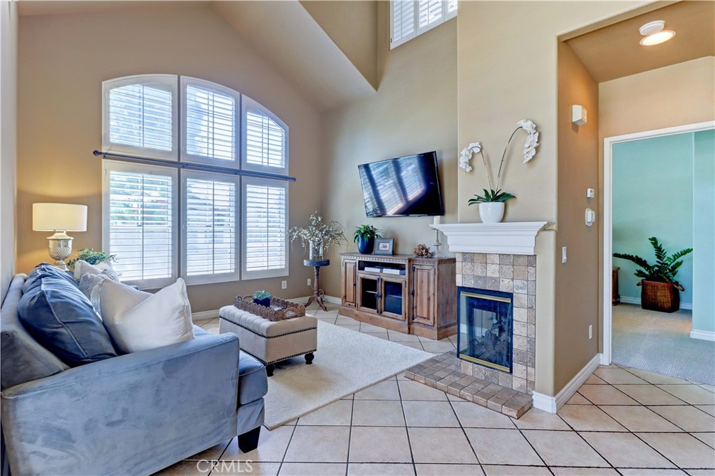 END UNIT condo in St. Tropez with NOBODY LIVING ABOVE OR BELOW. PRIVATE PARKING FOR 3 CARS (attached garage, driveway and 1 assigned parking space right across from the driveway). HEATING & AIR REPLACED. As soon as you hit the top of the entry stairs, you are wowed by the dramatic ceilings and many large windows that make it feel spacious and airy. PLANTATION SHUTTERS have been added throughout the house. Nice, open floorplan with a large balcony off the dining room that expands your living space. The balcony is private and the neighboring buildings are at a substantial distance. The kitchen is surrounded by large windows and you will love the view out to your balcony and the many palm trees in the backdrop. All stainless kitchen appliances are included (dishwasher is brand new). A privacy door and plantation shutters have been added to enclose the upstairs loft and once up there, you will find a full bathroom, closet, peaked ceiling with a ceiling fan & a 2nd outdoor balcony. Brand new carpet just installed on staircases and in bedrooms. There are 3 ceiling fans in the house to keep you cool. Interior laundry on the primary bedroom level with W/D included. Neighborhood saltwater pool & spa is just across the parking lot. GATE ACCESS from St. Tropez to ARGONAUT PARK NEXT DOOR. The park runs the full length of St. Tropez & has a playground, basketball court, picnic area & plenty of grass. HOA has re-piped with PEX. Walking distance to a fantastic newer dog park, Starbucks, Aliso Viejo Town Center, schools, various parks, tennis courts, golf and the aquatic center. Quick access to the 73 Toll Rd. Just minutes to beautiful Laguna Beach. No Mello Roos. FHA & VA approved. HOA is currently in the planning to do some wood replacement and paint the buildings & garage doors. There is talk of changing the exterior color to give the neighborhood a fresh new look.