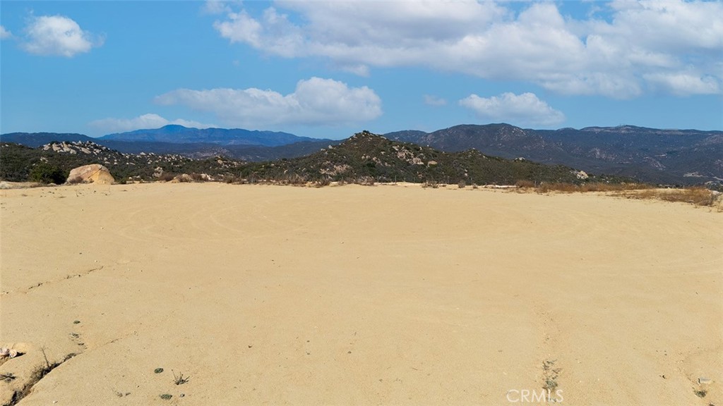 You Can get a loan for this land purchase with only 20% down payment with U.S Bank and they also offer land to construction loan. NEW IMPROVED PRICE FOR A FAST SALE! You must walk this property in person to truly experience its breathtaking mountaintop views, quietness and refreshing breath of fresh Air. The pictures simply cannot capture the beauty and serenity this property offers and don't do the justice. Discover your dream oasis on this stunning 5.78-acre property, offering breathtaking panoramic views of the city and valleys in the prestigious La Cresta Highlands community in Murrieta, CA. This rare gem provides the perfect canvas for building your custom dream home, blending serene living with the convenience of being just 20 minutes from the major 15 Freeway. As you arrive from the paved road, you’ll be greeted by a majestic oak tree, with beautiful rock formations and additional oak trees scattered across the land, creating a picturesque setting. The home site has been thoughtfully graded and certified by Riverside County few years ago, featuring two graded pads—ideal for your vision. Design your perfect mountain retreat with one pad for your dream home and the other for an RV garage, barn, guest house, ADU, or any feature that fits your lifestyle. Nestled in the heart of La Cresta Highlands, this property boasts unmatched tranquility and proximity to outdoor adventures, including the Cleveland National Forest, horse trails, the Santa Rosa Plateau, and Sylvan Meadows—making it a haven for nature lovers and outdoor enthusiasts. Active Water meter is already at the property with the meter box, while electricity is available on the street. Located within the award-winning Murrieta School District, this property offers endless possibilities to create your ideal custom home in a highly sought-after community. Don’t miss this extraordinary opportunity to own your private slice of paradise!