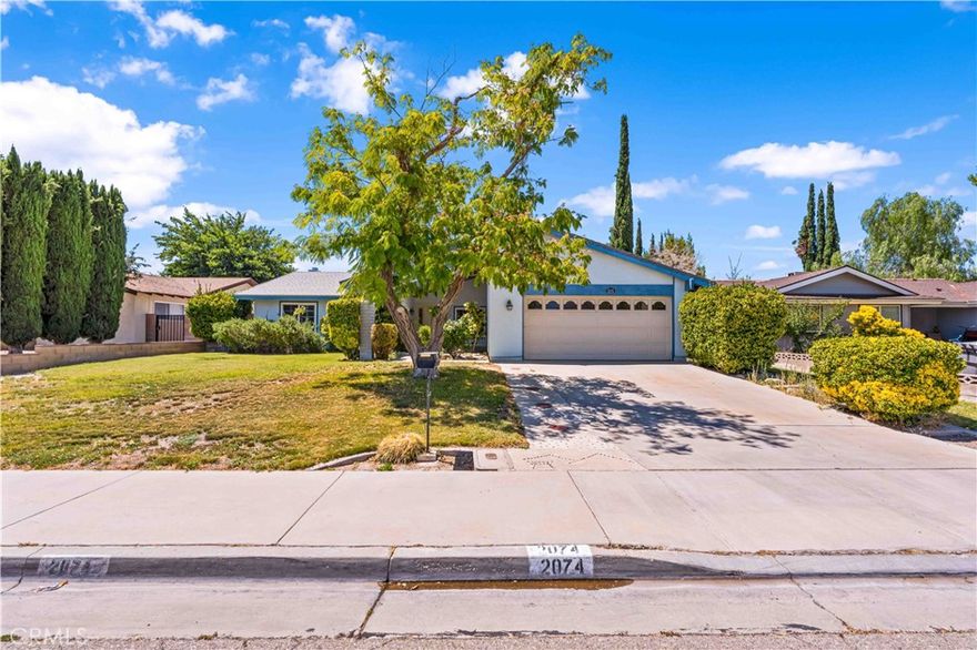 Great Opportunity Here! FOR SALE BY ORIGINAL OWNERS! This 3 bedroom 2 bath single story offers 1,588 square feet of living space.
Huge formal living/dining room combo with a floor to ceiling brick fireplace, tall vaulted ceiling and two sliding doors that lead to an enclosed patio. The kitchen is spacious and has large windows for plenty of natural light. Upgraded dual pane windows throughout and a NEW HVAC unit installed in 2020! The primary bedroom has its own private bath with the remaining two bedrooms and bath on the opposite side of the house. The backyard offers a ton of privacy with tall block walls, wraparound patio, a variety of fruit trees and lush landscaping. Located in a quiet West Lancaster neighborhood!