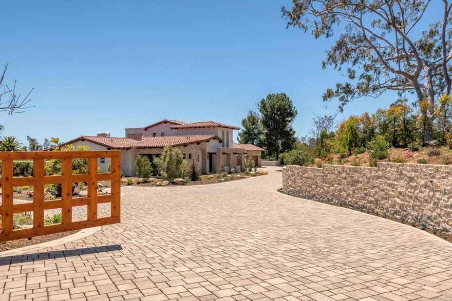 Behind private gates, tucked into the village of Rancho Santa Fe on acreage that was once part of The Inn. Beautiful, brand new single family modern European home. Primary suite plus office on the main level. 3 bedrooms, 3 ½ baths, wine room, coffee bar, private pool, spa, 3-car garage. With breathtaking views out to the San Dieguito River Valley, in an unrivaled location just minutes from the Pacific Coast and within easy walking distance to the Rancho Santa Fe Village, Golf Course and Tennis Club. Enveloped by mature trees and Mediterranean, drought-resistant plants, the landscaping is designed to burst with color for year ‘round delight. Fresh Italian-inspired architecture incorporates stone, plaster, stacked tile roofs in a timeless color palette. Thoughtfully designed with wide, light and bright halls and doorways. In addition, construction has been reinforced for the future installation of special amenities to accommodate residents remaining in and enjoying their home for years and even decades to come. Private, fully-fenced, gracious outdoor areas accessed by expansive La Cantina doors to enhance easy indoor and outdoor flow. Inside exudes style, warmth and comfort amidst beautifully scaled rooms with incredibly well-appointed features including tall, accent beamed ceilings, wide Maple plank or stone floors, primary bath with wet room and heated floors, private balcony, hand crafted fireplaces, designer light fixtures and masterful kitchen design with quartzite/granite countertops and top-of-the-line Dacor stainless steel appliances. Sizable storage and closets abound. Fully-owned solar. Garage is outfitted with electric vehicle outlets.