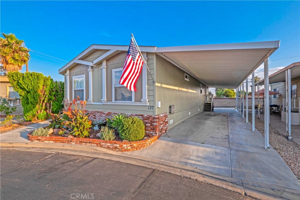 Beautiful "Model" manufactured home in the beautiful city of La Verne! Home features an open floor plan.. There is a spacious living room, formal dining room and breakfast bar. Kitchen features beautiful kitchen cabinets with a new ceramic kitchen sink and faucet. Kitchen has all stainless steel appliances with a double convection oven with a 5 burner stove. There is an over the range microwave. All bedrooms are spacious with ceiling fans.. The master bedroom is simply GORGEOUS with its own bathroom with double sinks. Master bathroom has additional cabinets for your linens. This is a rare find, but this home has a yard and this one is beautifully landscaped with new grass and new vinyl fencing. There is a pergola with new concrete and walkways. There is also a large Tuff Shed with electricity. There is so much pride of ownership in this home .... Show and Sell!