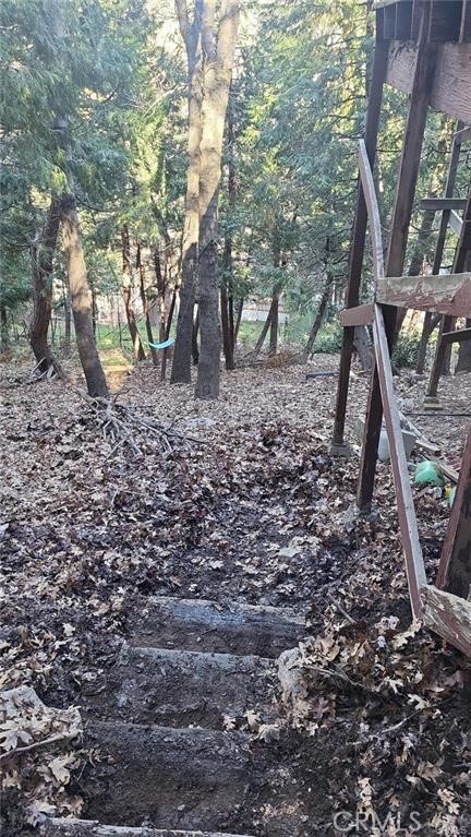 Back on the Market and reduction in selling Price!!! 4,988 Sq ft vacant lot with a downward slope in a serene forest neighborhood setting. Less than a mile from Lake Gregory. Street access from the top. Buyer and Buyers agent to perform due diligence regarding utilities, zoning, permits, lot size, etc. Seller is VERY MOTIVATED!