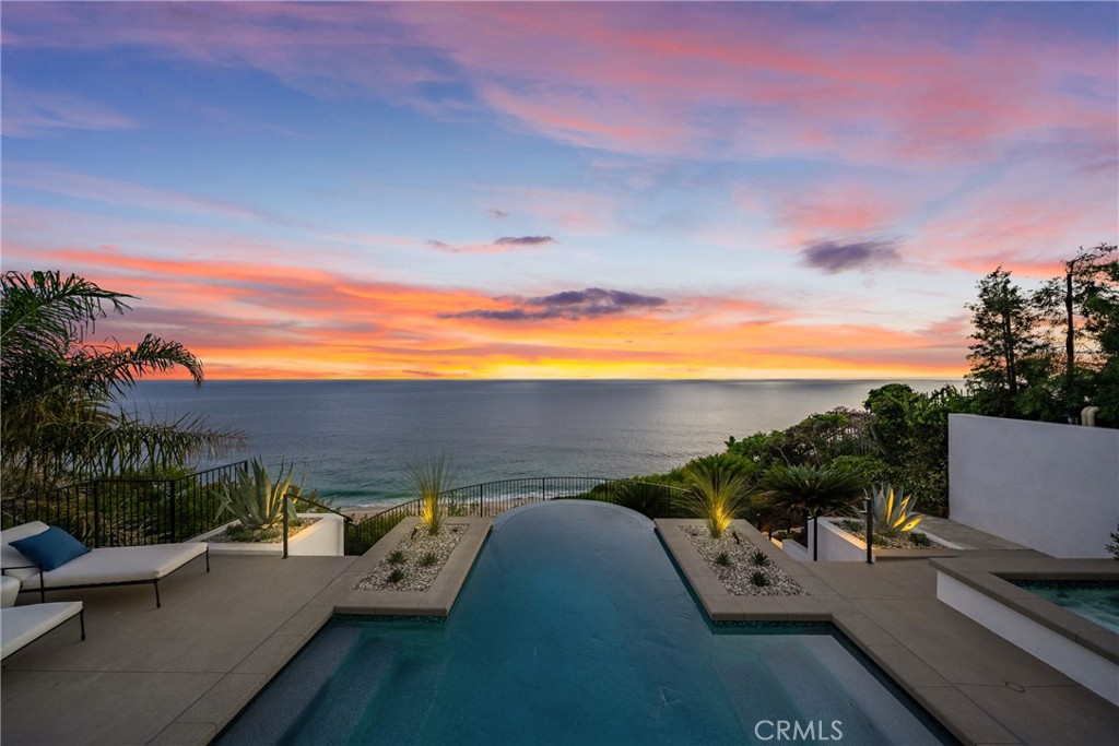 Perched majestically on a half-acre oceanfront bluff overlooking the beautiful Southern California coastline, 32101 Coast Hwy embodies the epitome of luxury Laguna Beach living. This stunning estate features panoramic white water, ocean, Catalina Island, sand, and coastline views. A one-of-a-kind home, it has been completely remodeled to the highest quality. A large bluff-top infinity pool with spa and pool house boast panoramic vistas: an architectural rarity that would never be approved if submitted today. This home was transformed into a contemporary Santa Barbara-style masterpiece by renowned architect James Conrad. Upon entry, the sprawling main level open floor plan immediately captivates with stunning panoramic ocean views. The main level features a spacious living room, dining room, gourmet chef's kitchen, powder room, luxurious primary suite, and magnificent outdoor decks all designed to maximize natural light and ocean vistas. The seamless flow extends to the lower level, where a large family room opens onto the expansive deck overlooking the pool, spa, and ocean. The lower level features three bedrooms, three bathrooms with immaculate tile work, spacious laundry room, and direct access to the pool deck, seamlessly blending indoor and outdoor living. Additional interior touches include incredible custom tile flooring, with ceilings featuring white oak beams and tongue & groove design. Moving outside, lush landscaping and a fully remodeled pool, spa, and waterfall delight the senses. Additionally, the pool house features a beautiful bathroom and bar. New roofing strategically integrates solar panels into the shingles. Three new sets of pocket doors and exterior steel doors with marine-grade finish, plus a brand-new Euroline steel front entry door complete the picturesque appearance. Every detail of this virtually brand-new home has been meticulously curated. The extensive three-year renovation included structural enhancements, updating the plumbing, electrical, & HVAC with state-of-the-art systems, and installation of top-quality windows. For a turnkey experience, the brand new elegant furnishings are available for purchase.
32101 Coast Hwy not only offers a luxurious residence, but a lifestyle characterized by coastal serenity and sophistication. Ideal for those seeking the ultimate in beachfront living, this property invites you to experience the pinnacle of Laguna Beach's coastal charm and beauty. Your one-of-a-kind coastal oasis awaits!